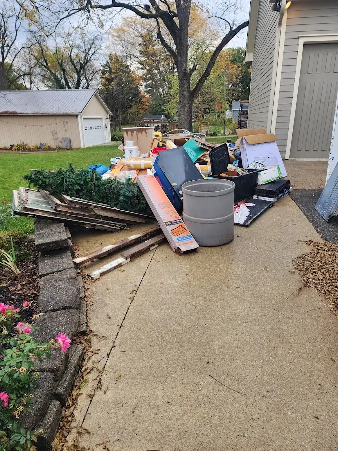 Dumpster being loaded with debris for Commercial Dumpster Rental in Woodstock
